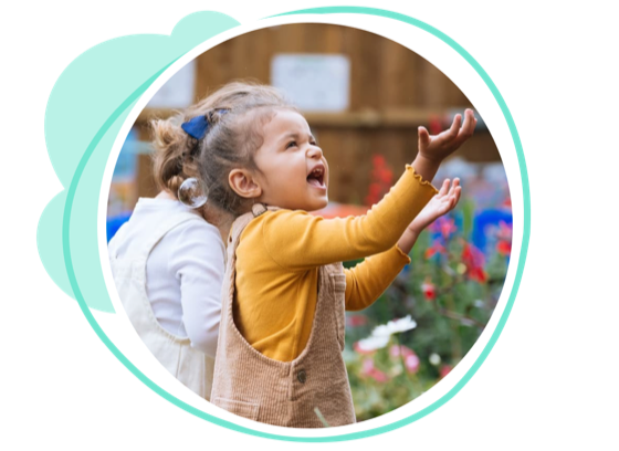 A happy child reaching up, playing outdoors