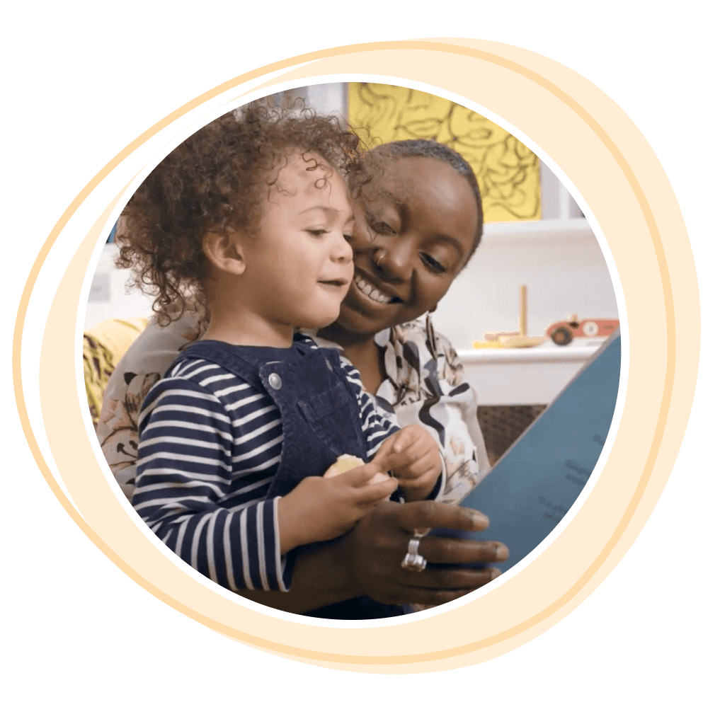 A childminder reading with a small group of children